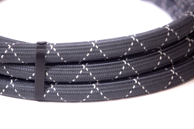 Coiled gray braided cable on a white background
